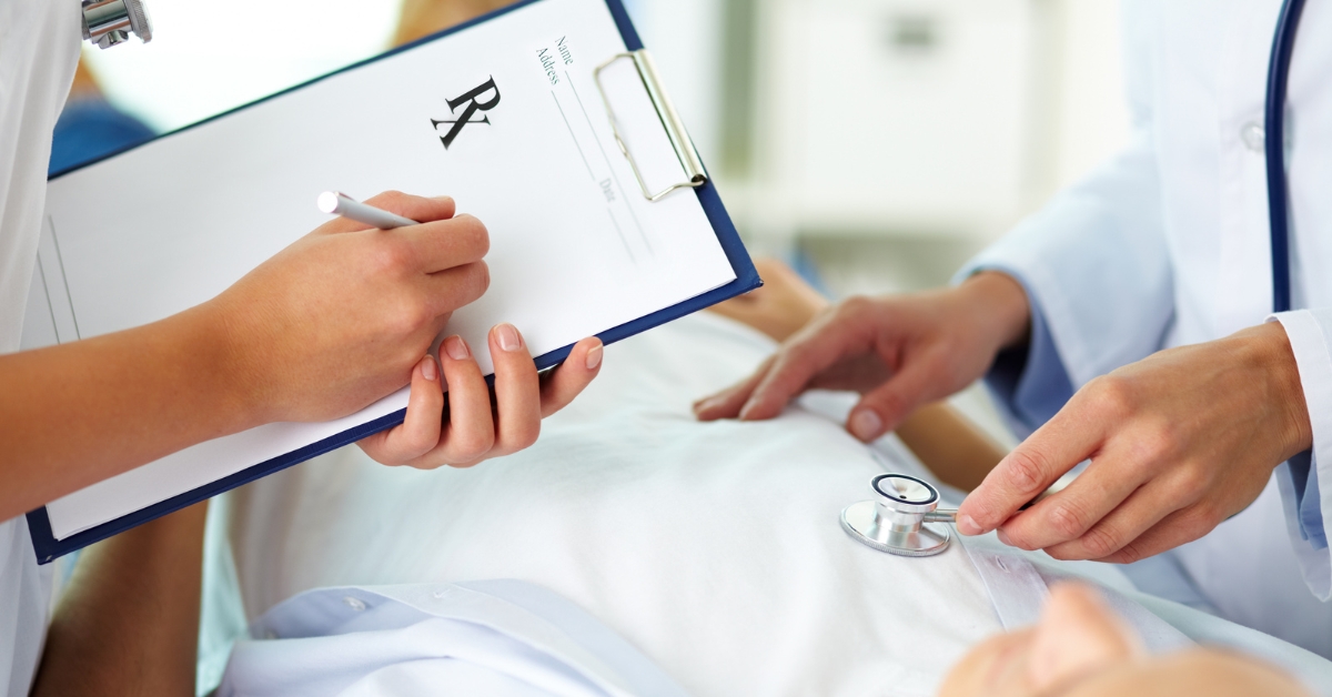 A doctor writing a prescription and examining a patient, highlighting treatment for ARFID naturally.