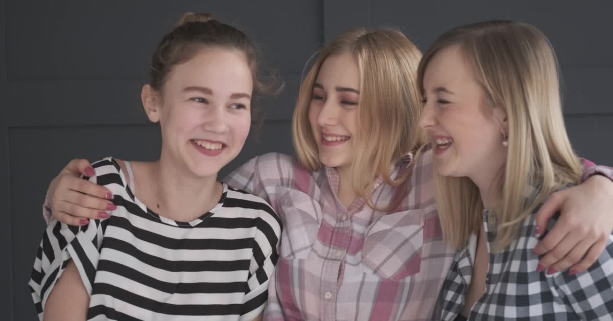 Three smiling teenage girls with arms around each other, illustrating the question "What is Teen Recovery?"