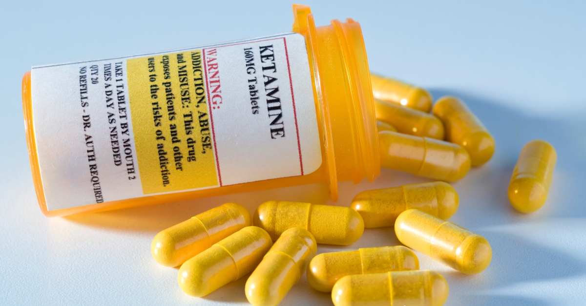 A pill bottle labeled Ketamine with yellow capsules spilled out, illustrating Ketamine Treatment for Depression.