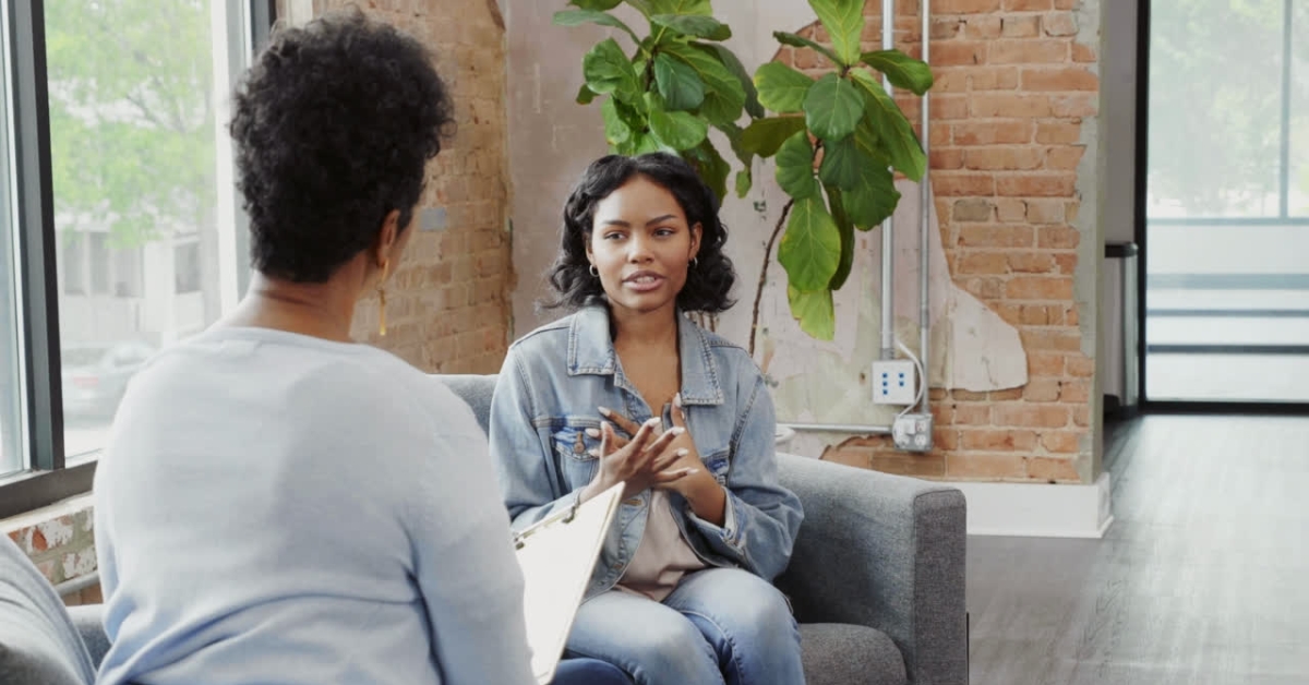 A teenager talking to a counselor in a cozy office, highlighting the importance of teen counseling.