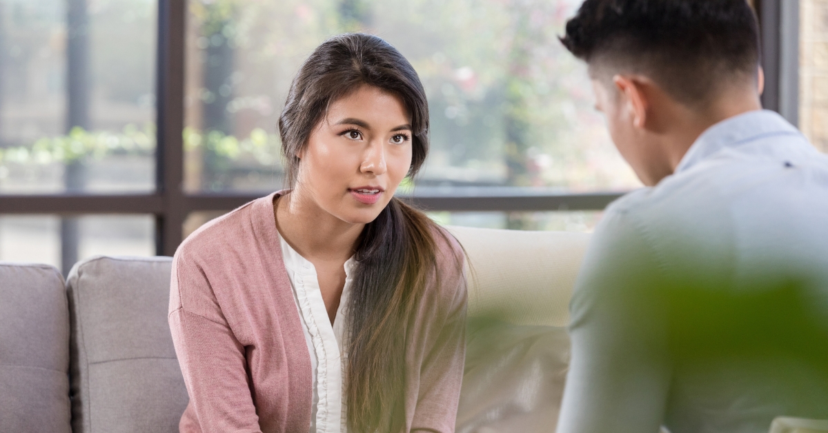 A woman talks to a therapist in a bright room, illustrating the process of Seeking Mental Health Treatment.