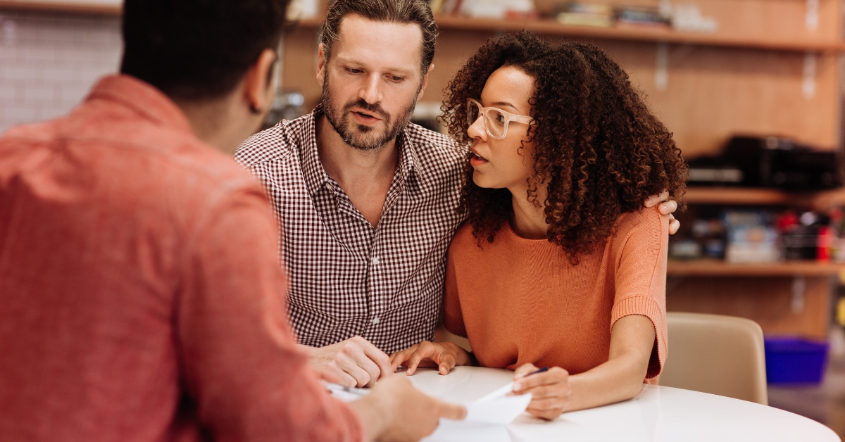 Parents consulting with a professional, emphasizing the importance of choosing the right youth support services for your child.