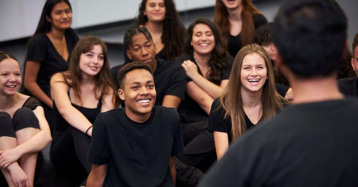 Group of teenagers laughing and engaging in a discussion, representing Teen Mental Health Resources.