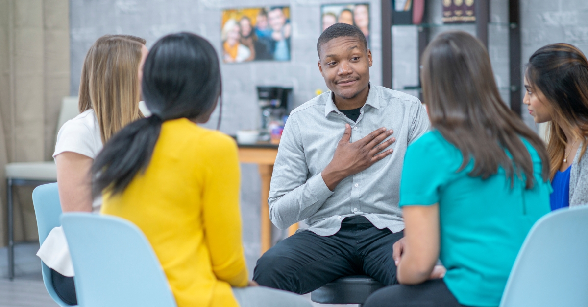 A diverse group of teenagers sitting in a circle, participating in teen group therapy.