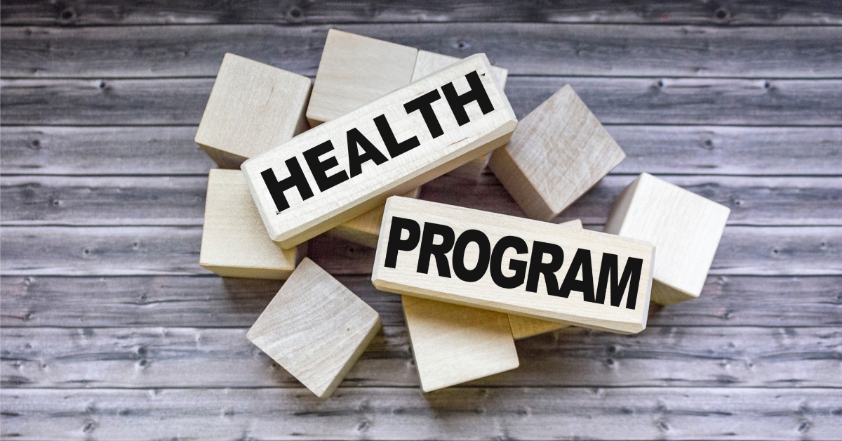 Wooden blocks with the words "Health Program," emphasizing health programs for adolescents.