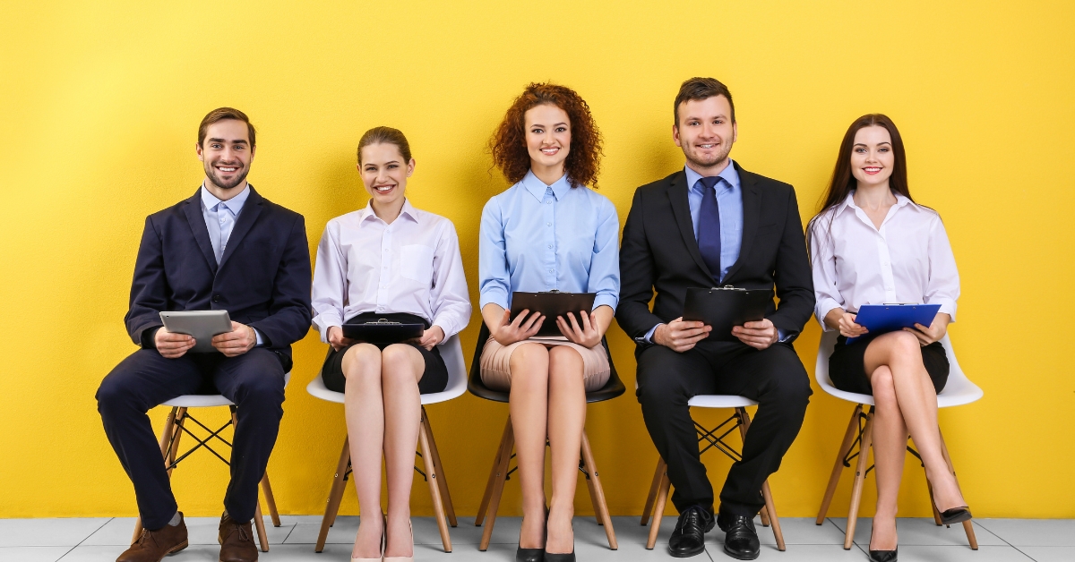 A group of professionally dressed individuals sitting in a row, illustrating the best jobs for people with social anxiety.