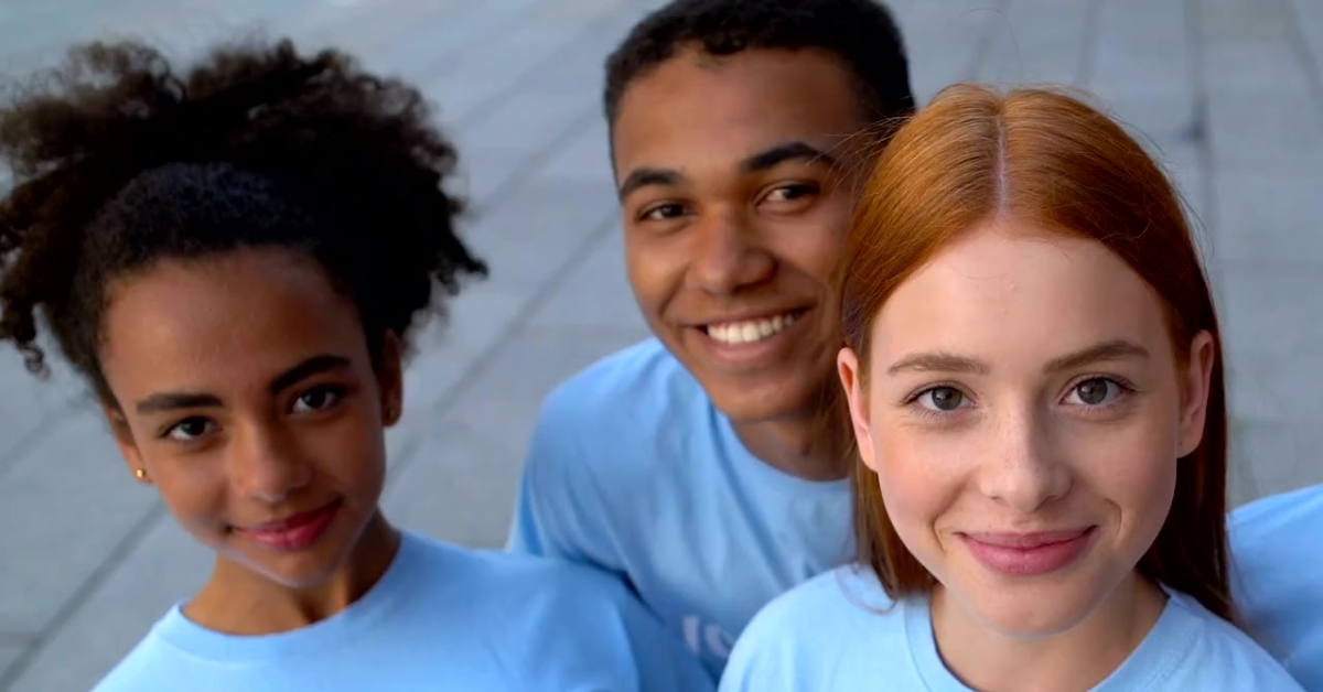 A group of smiling teens standing close together, representing the importance of healing programs for teens.