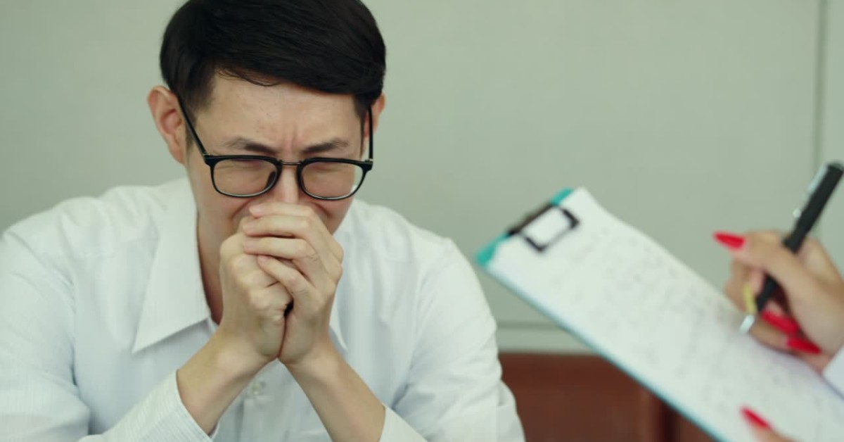 Man in distress during a therapy session, illustrating genetic predisposition to anxiety disorders.