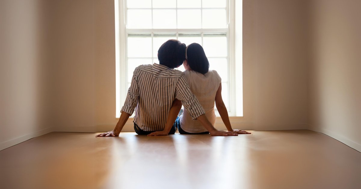 A couple sits closely by a window, showing how mental health affects personal relationships deeply.