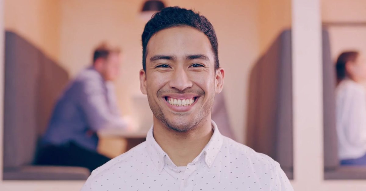 A smiling man highlights how mental health's impact on physical well-being can lead to positivity.