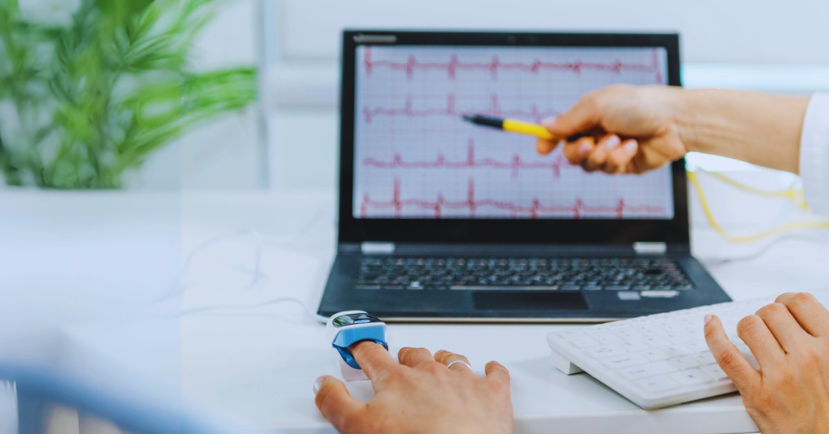 A person uses biofeedback equipment while monitoring heart patterns, highlighting biofeedback for anxiety reduction.