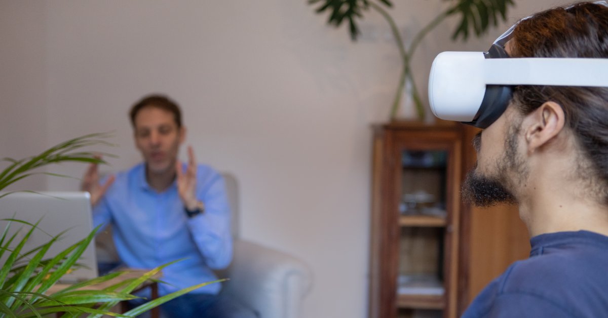 A person uses VR goggles during a session, demonstrating virtual reality exposure therapy for anxiety.