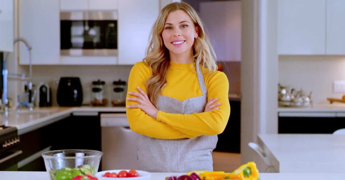 A woman standing confidently in a kitchen, promoting lifestyle changes to manage anxiety symptoms.