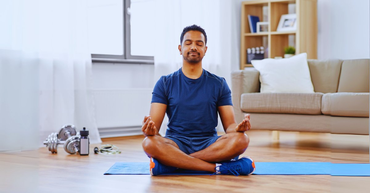 A man meditating in a peaceful home setting, practicing mindfulness for anxiety relief.