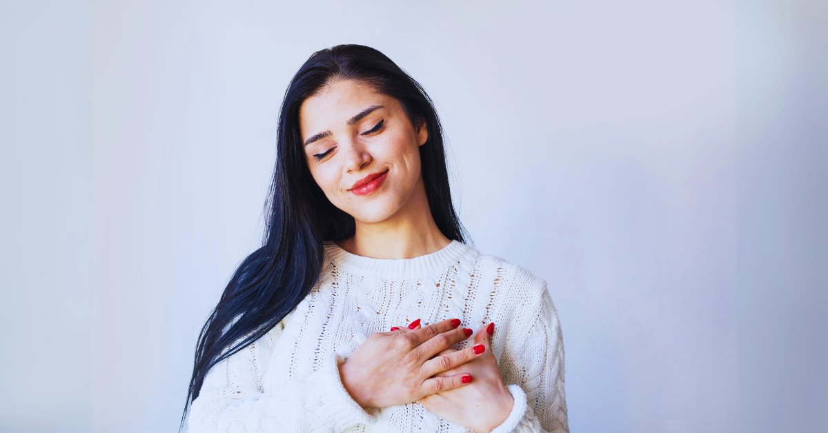 A woman practicing self-compassion, illustrating Acceptance and Commitment Therapy for anxiety disorders.